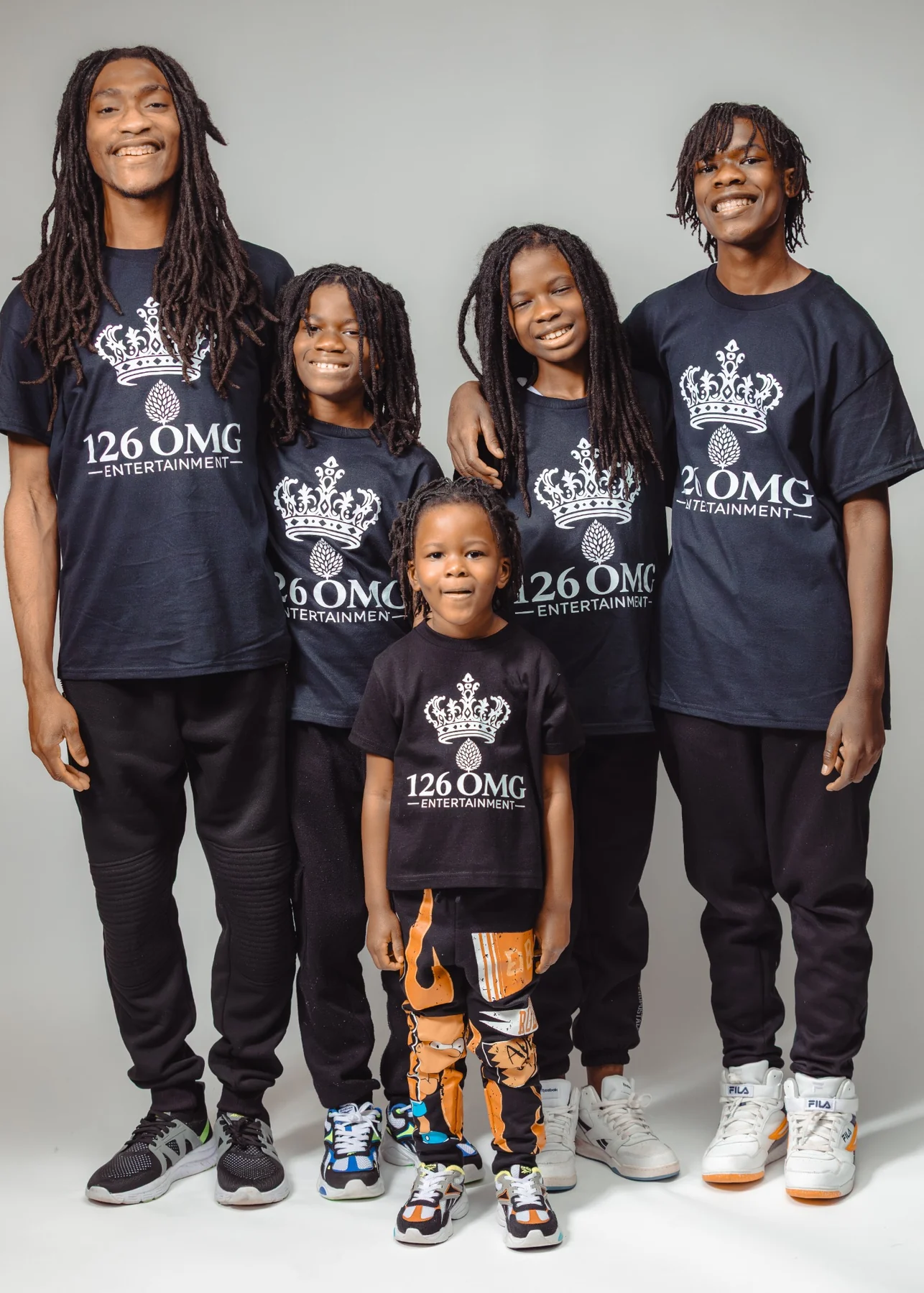 Five sons together in 126 OMG Entertainment shirts, shown in black and white